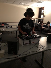 a person playing a dj set in a room